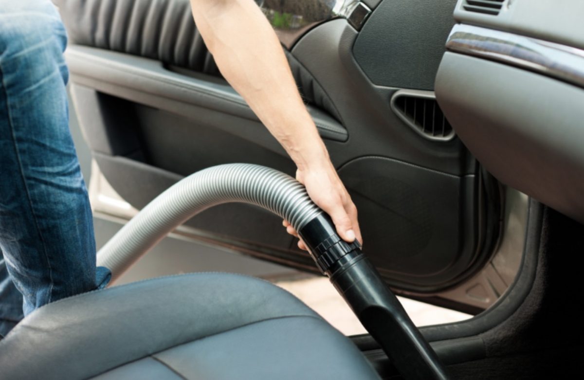 Person Using ShopVac to Clean Inside Car